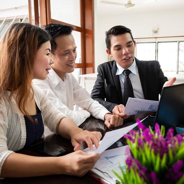 A young couple enjoying a lively discussion with their advisor about their future